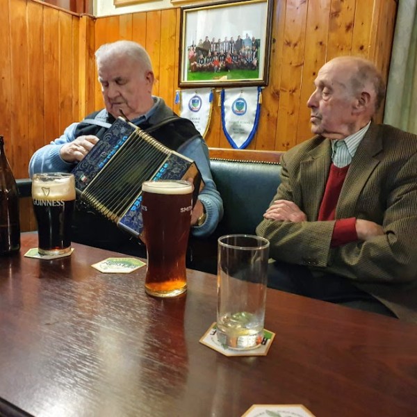 a person sitting at a table in front of a laptop