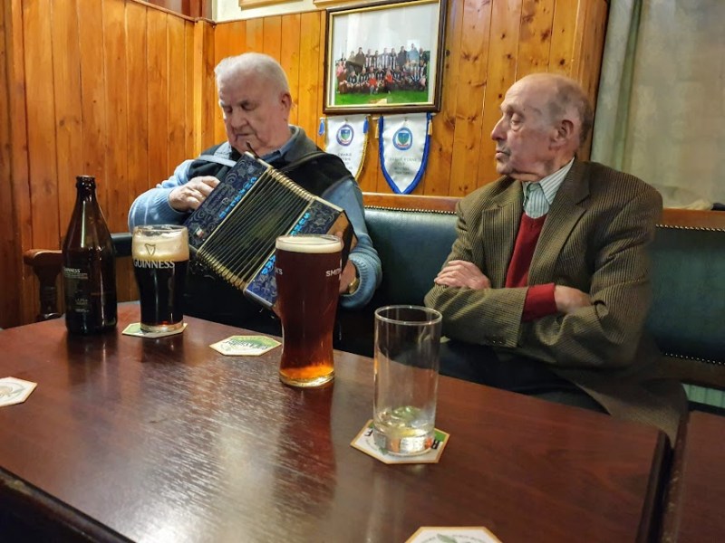 a person sitting at a table in front of a laptop
