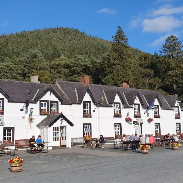a house that has a sign on the side of a road