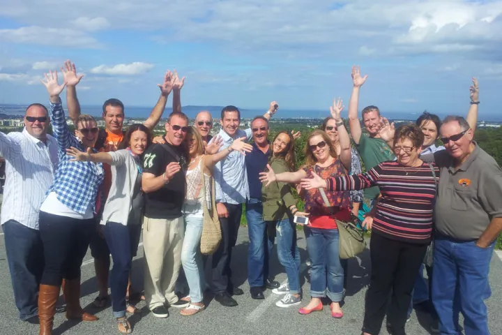 a group of people standing in front of a crowd posing for the camera