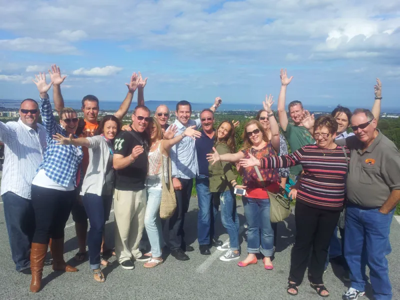a group of people standing in front of a crowd posing for the camera