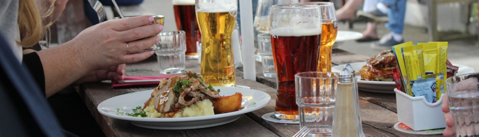 a person sitting at a table with a plate of food