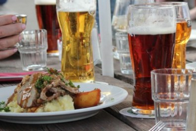 a person sitting at a table with a plate of food