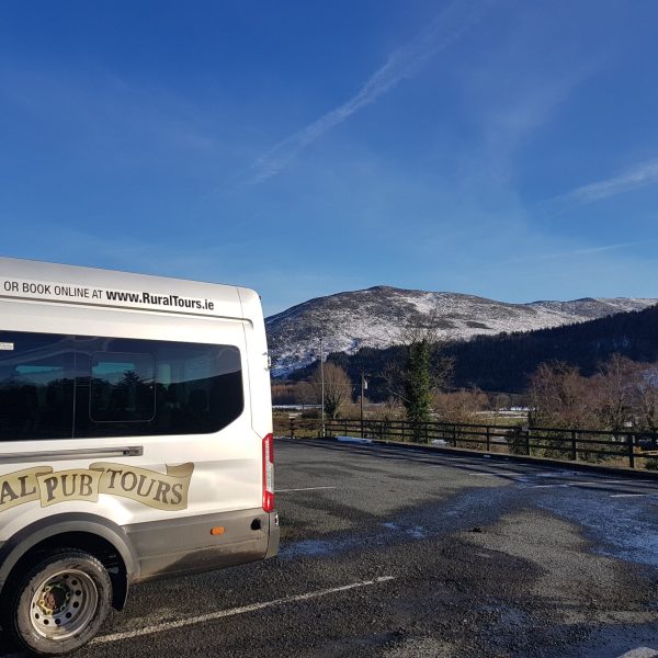 a bus driving down a dirt road