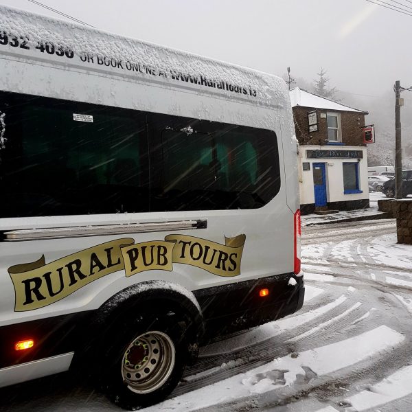 a truck is parked on the side of a snow covered road